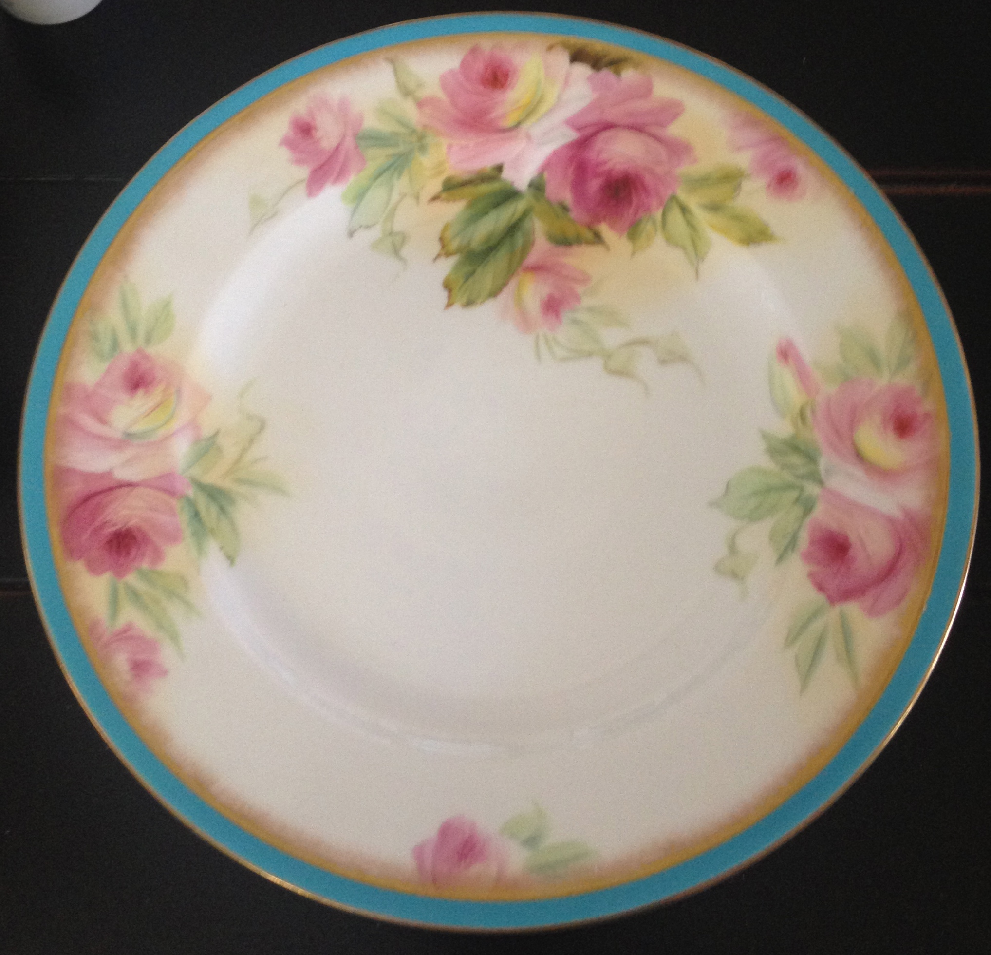 Vintage china with a turquoise and floral pattern.
